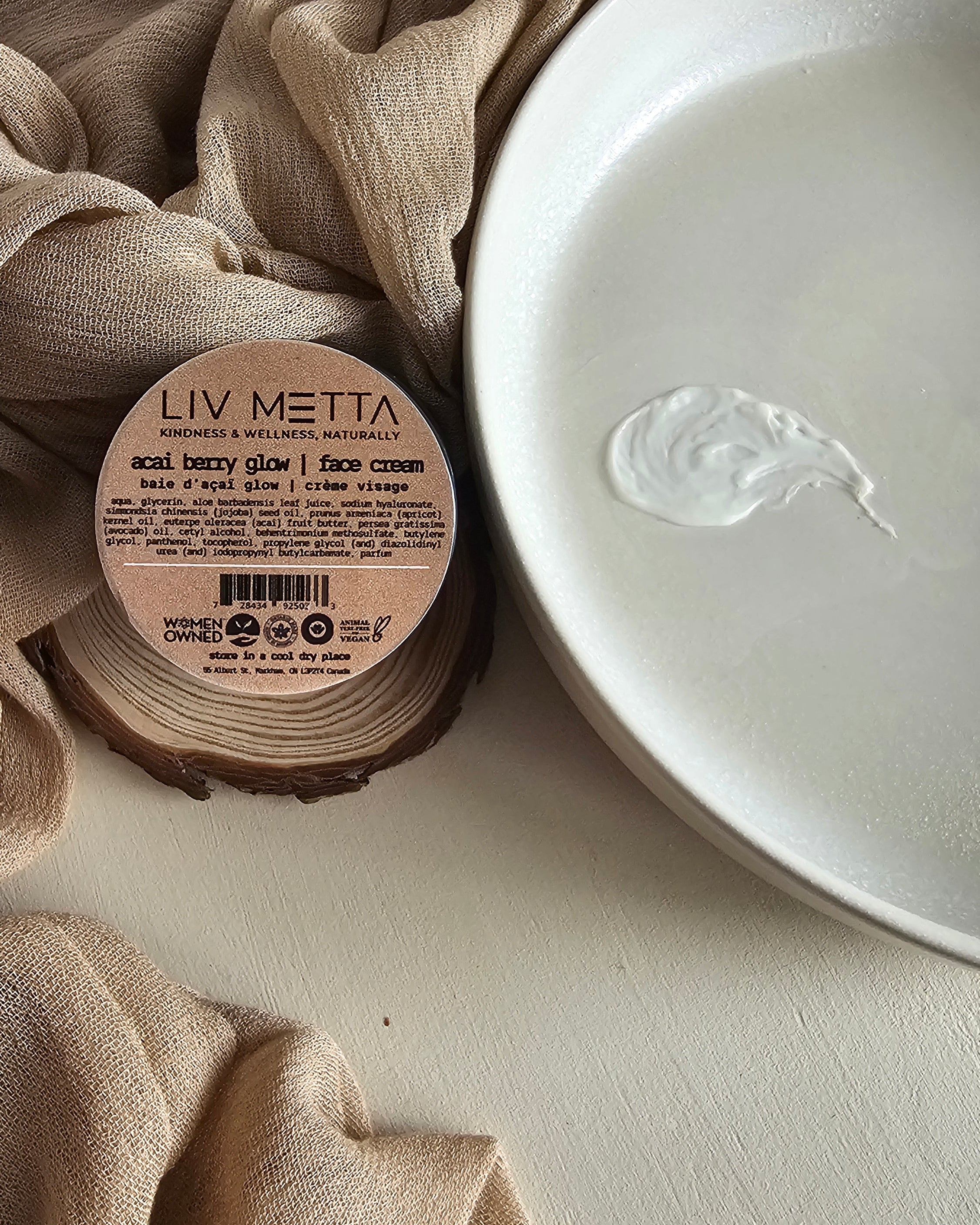 Jar of cream with a label on a beige fabric background