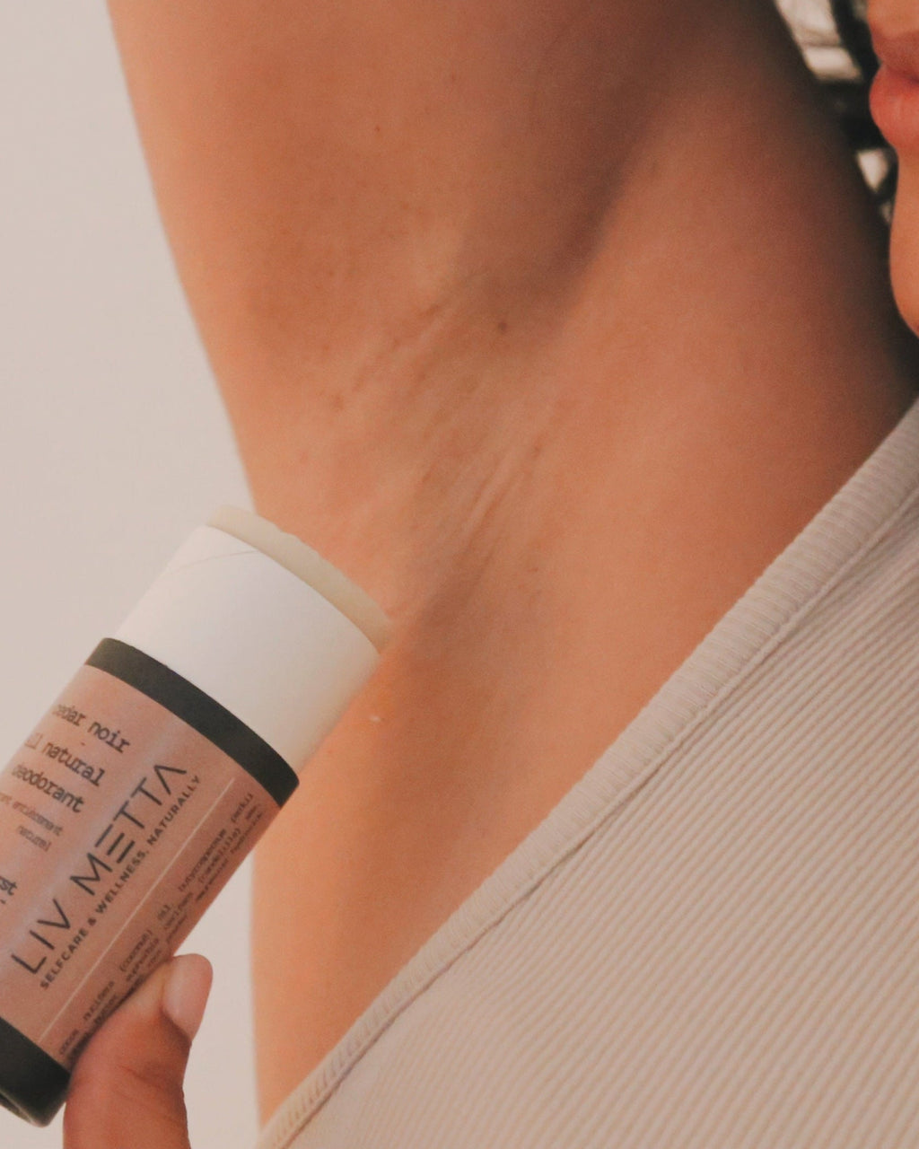 Person holding a LIV METTA product against a neutral background