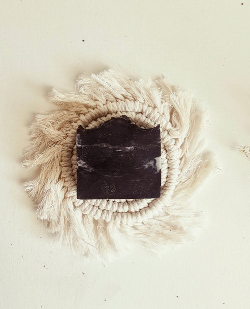 Charcoal Soap against a plan background