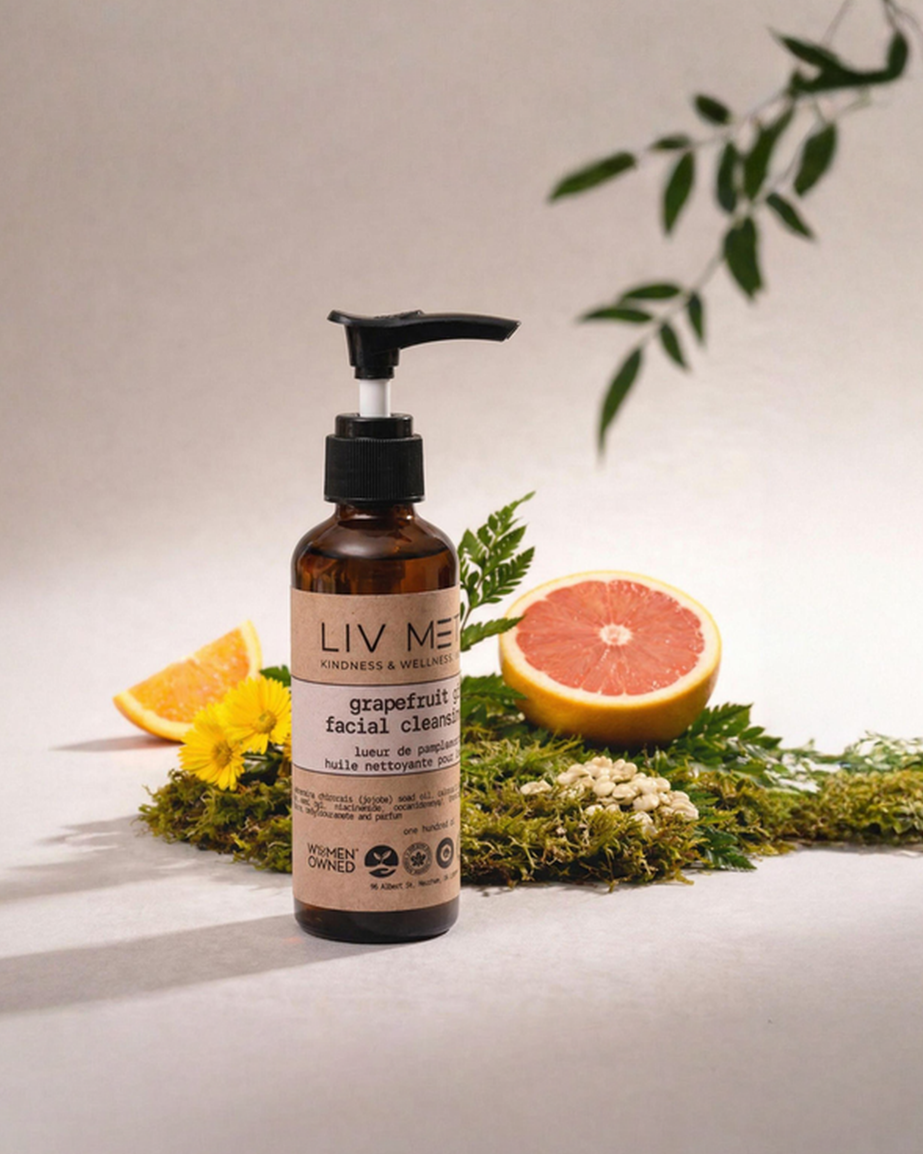 Bottle of LIV ME product with fruits and leaves on a neutral background