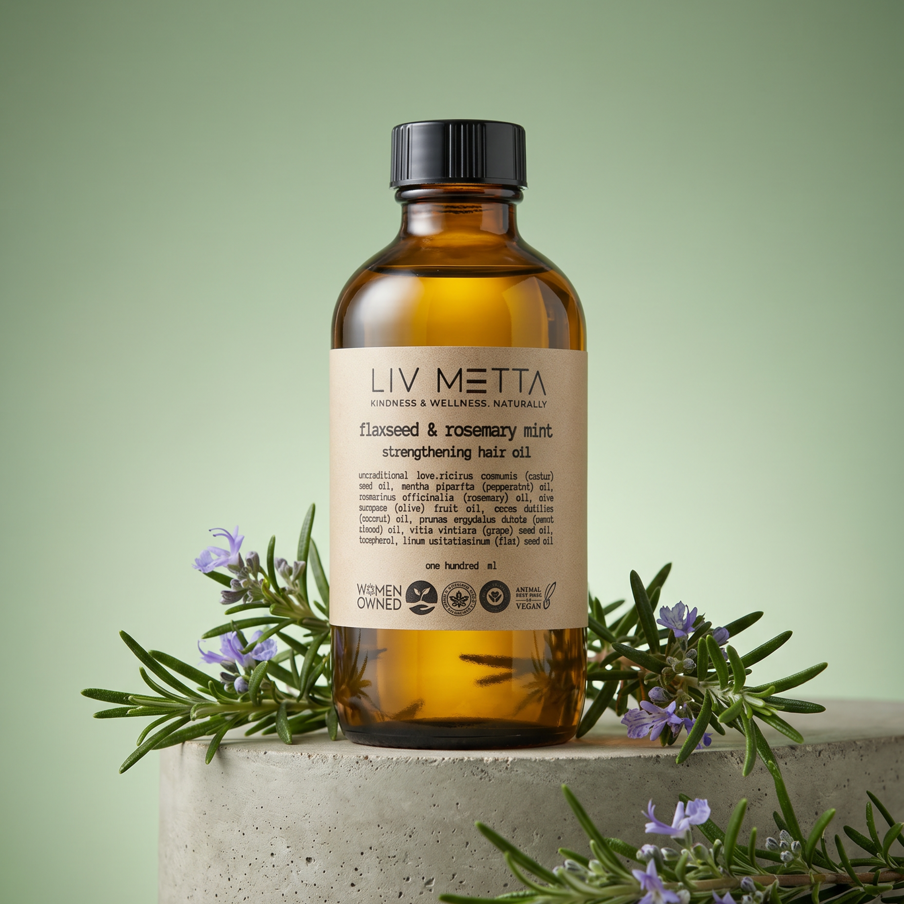 Bottle of LIV METTA hair oil with herbs on a light green background