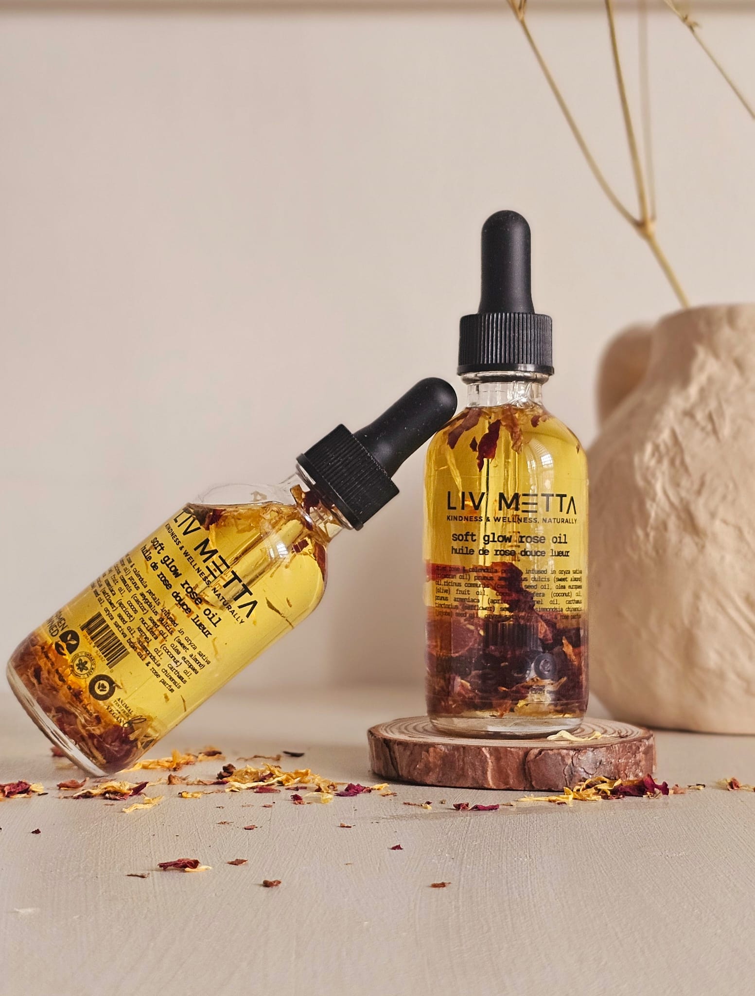 2 bottles on Rose Oil on a plain background