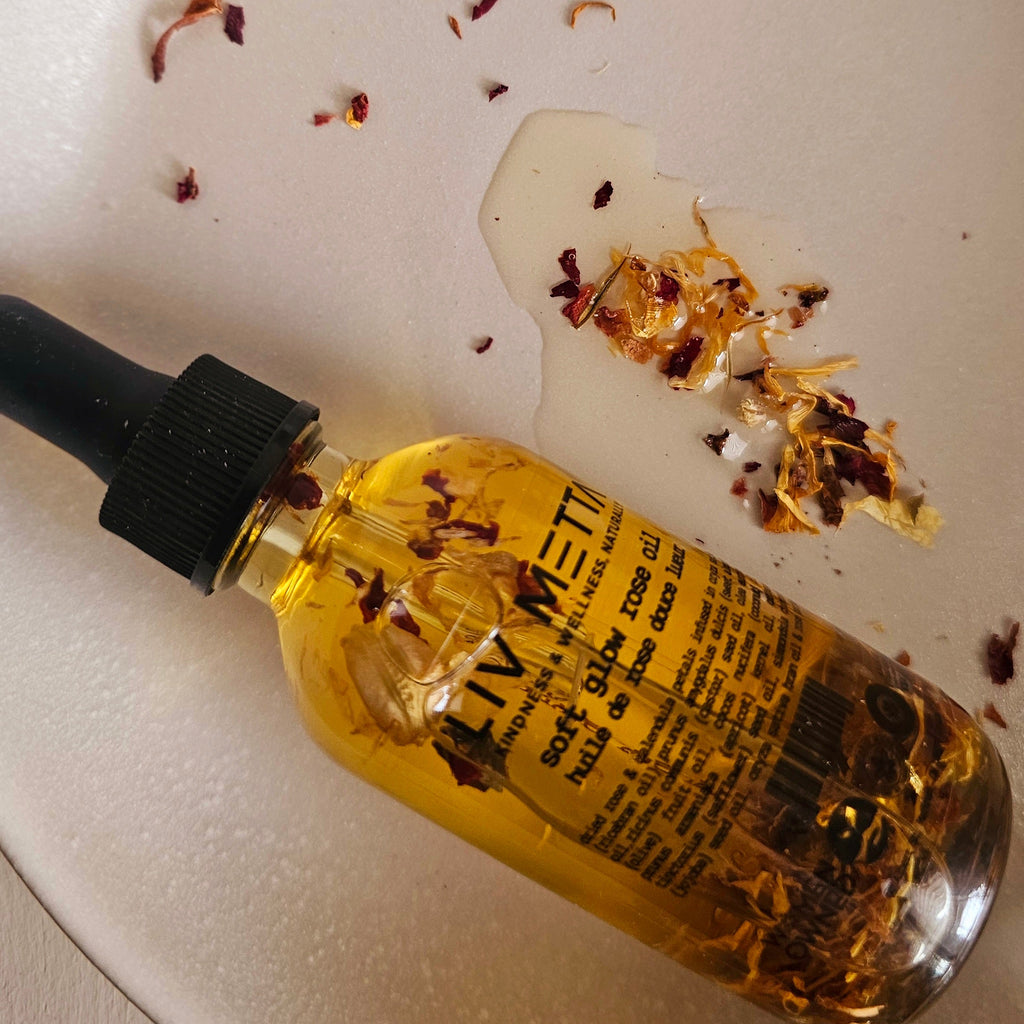 Soft Glow Rose Oil Close up with rose petals in a plate