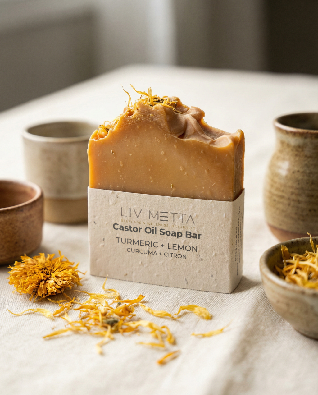 Bar of soap with 'Liv Metta' branding on a table with decorative elements