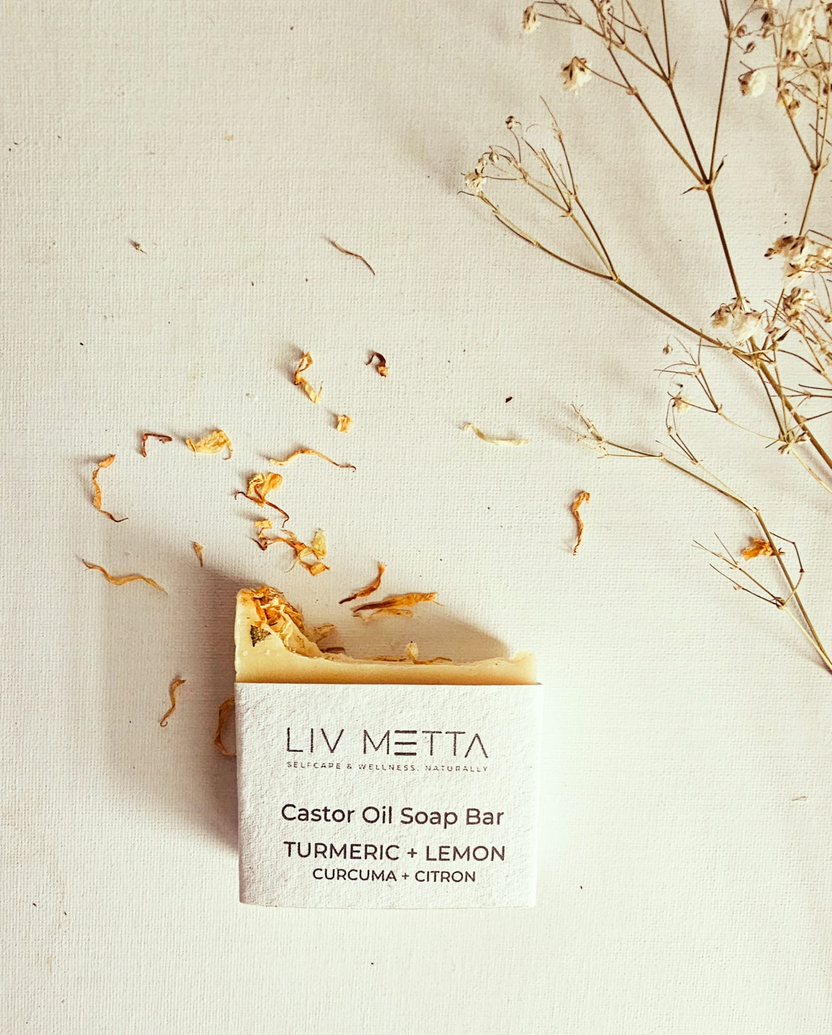 Castor Oil Soap against a white background with calendula petals 