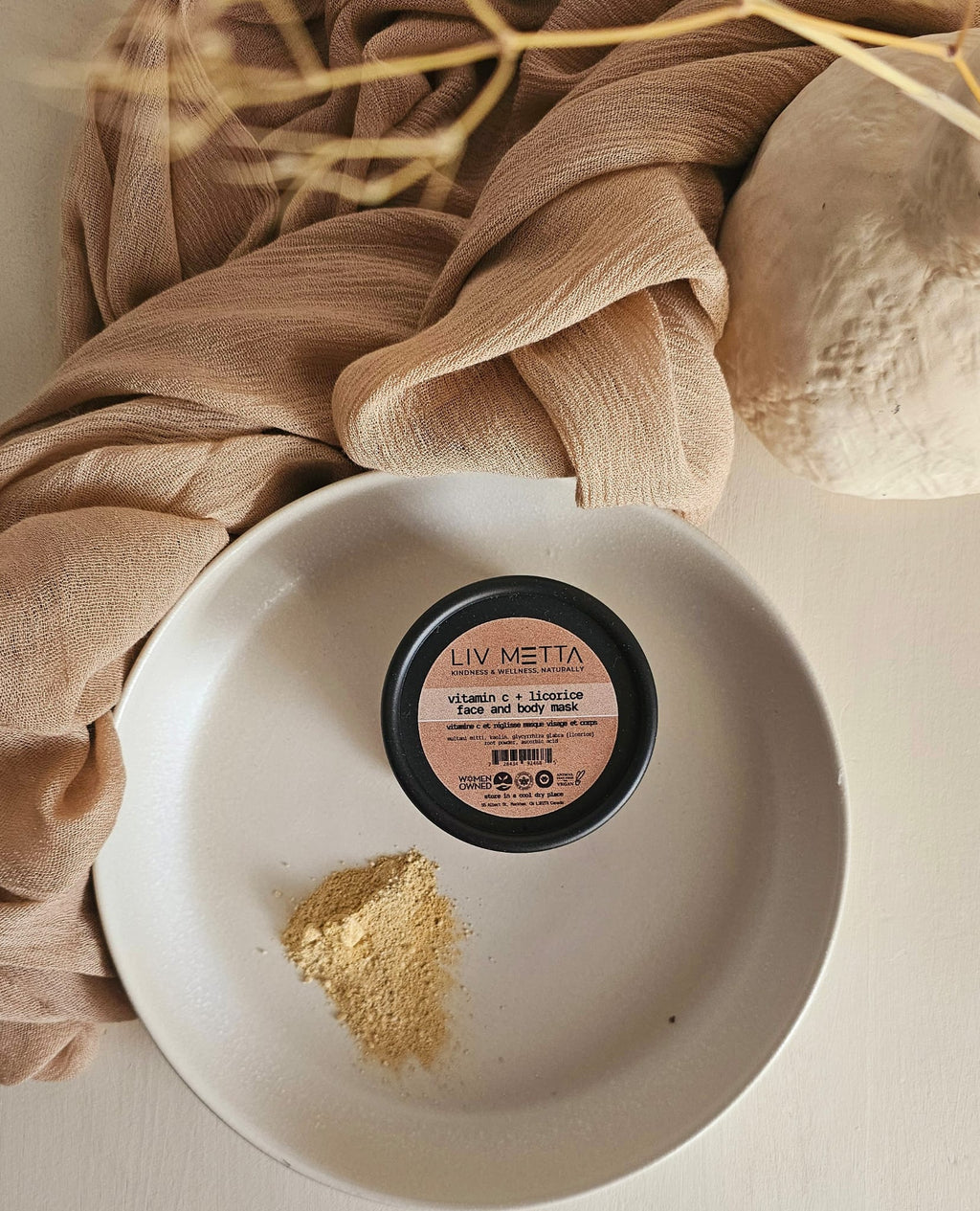 Black tub with powder on the side on a plate