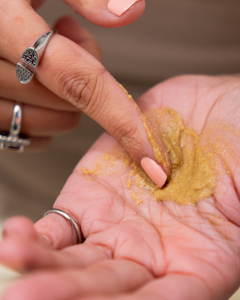 Mask in a paste in a womans hand
