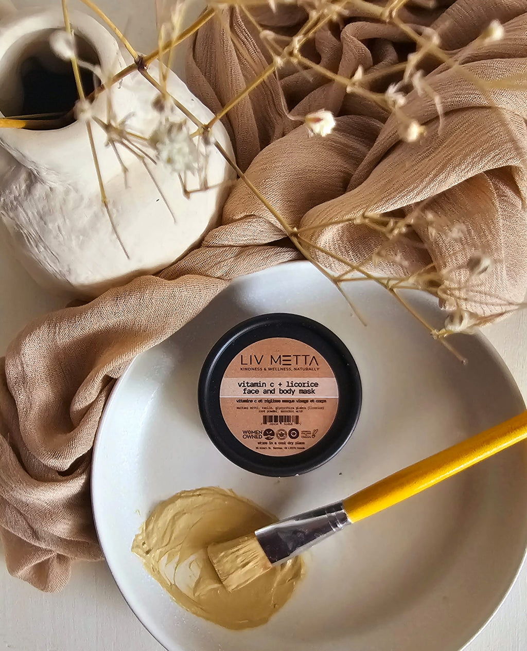 Black tub with paste on the side in a plate